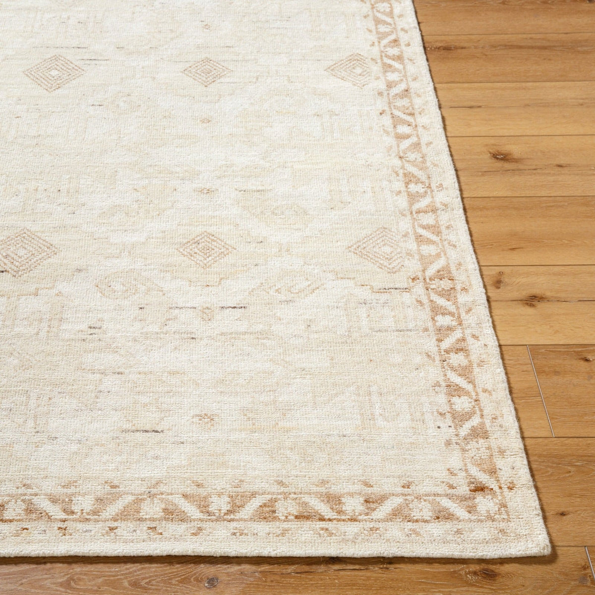 Close up of Agora rug texture showing artisan hand-knotted wool weave with subtle neutral tones
