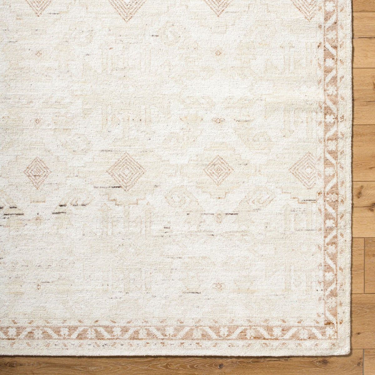 Close up of Agora rug texture showing artisan hand-knotted wool weave with subtle neutral tones