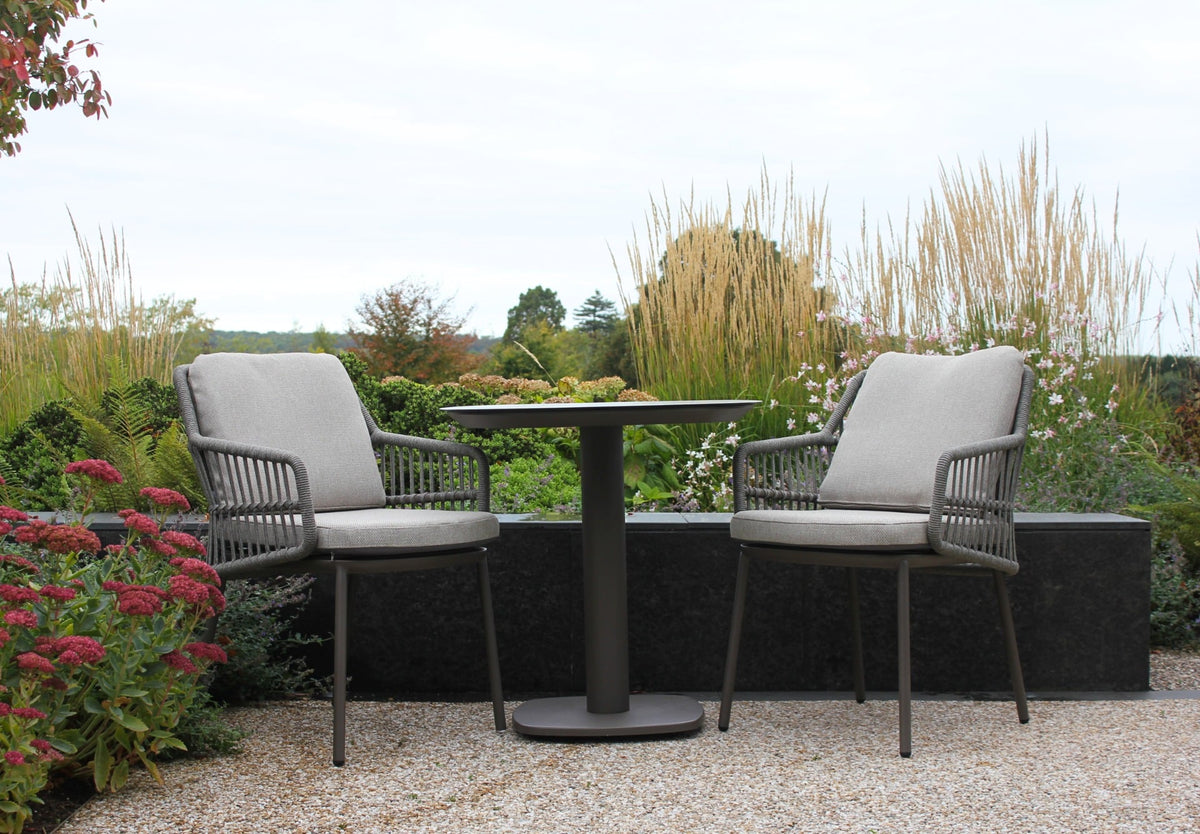 Alicante outdoor dining set with ceramic top and chairs on patio